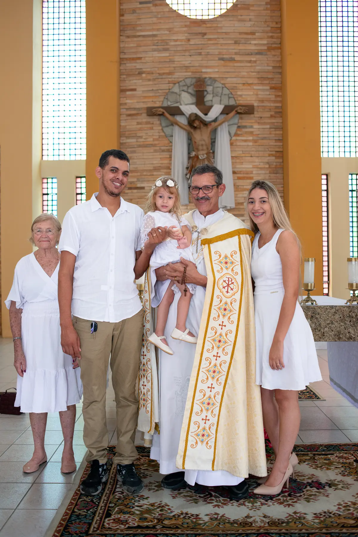 Adylla com a família e o padre na Paróquia Nossa Senhora de Fátima, em Caruaru