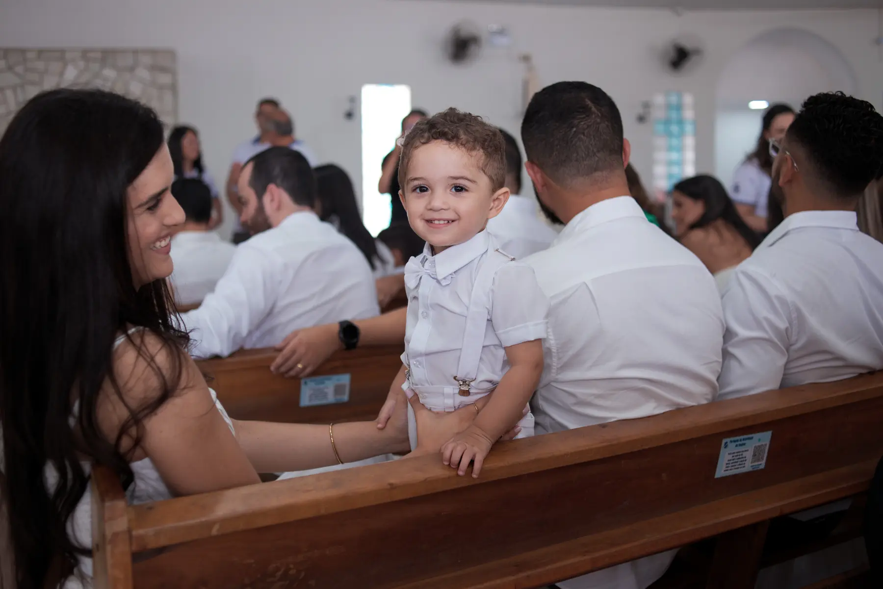 Heitor sorrindo com a mãe durante o batizado na Igreja da Natividade, em Caruaru